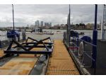 The boatlift with the towers of Canary Wharf in the background.